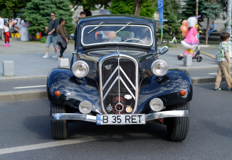 3 - A classic black Citroen Traction Avant, notable for its distinctive double chevron grille emblem